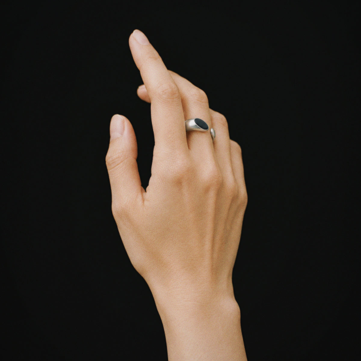 Model wearing the Umbra Oval Signet Ring in soft daylight