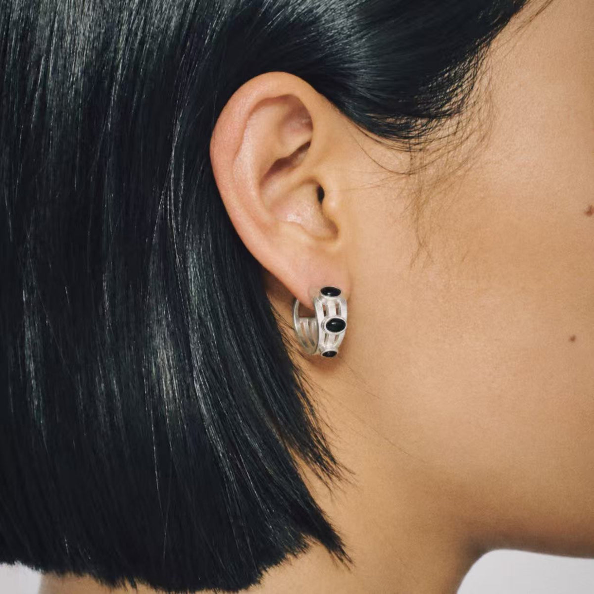 Model wearing Lil Cacti Vault Black Stone Hoop Earrings, close crop on the detail