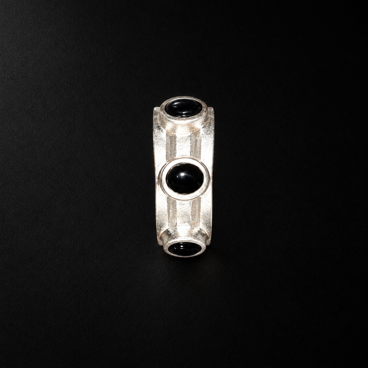Close detail of the Vault Black Stone Hoop Earrings surface and finish