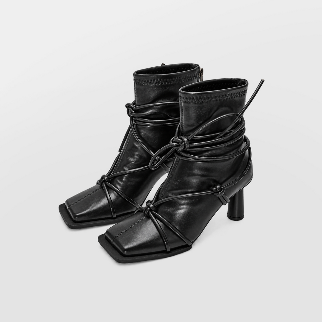 Verity Lace-Up Square Toe Boots by Lil Cacti — pair three-quarter view with cord laces tied in a bow around the ankle