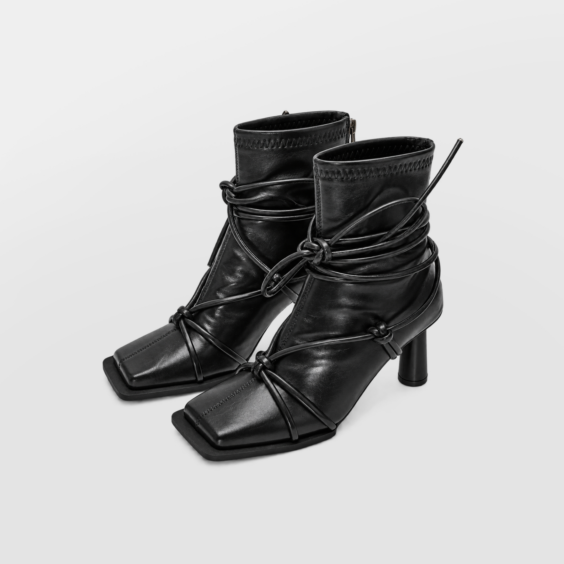 Verity Lace-Up Square Toe Boots by Lil Cacti — pair three-quarter view with cord laces tied in a bow around the ankle