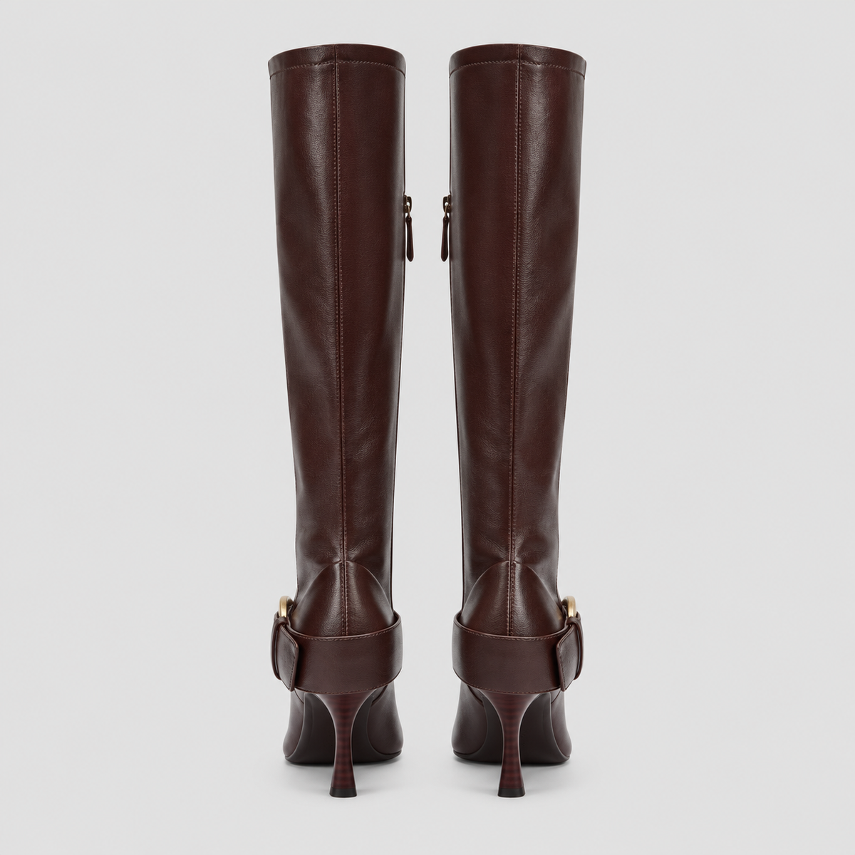 Rear view of both Vesper Buckle Tall Boots in dark brown, showing heel shape