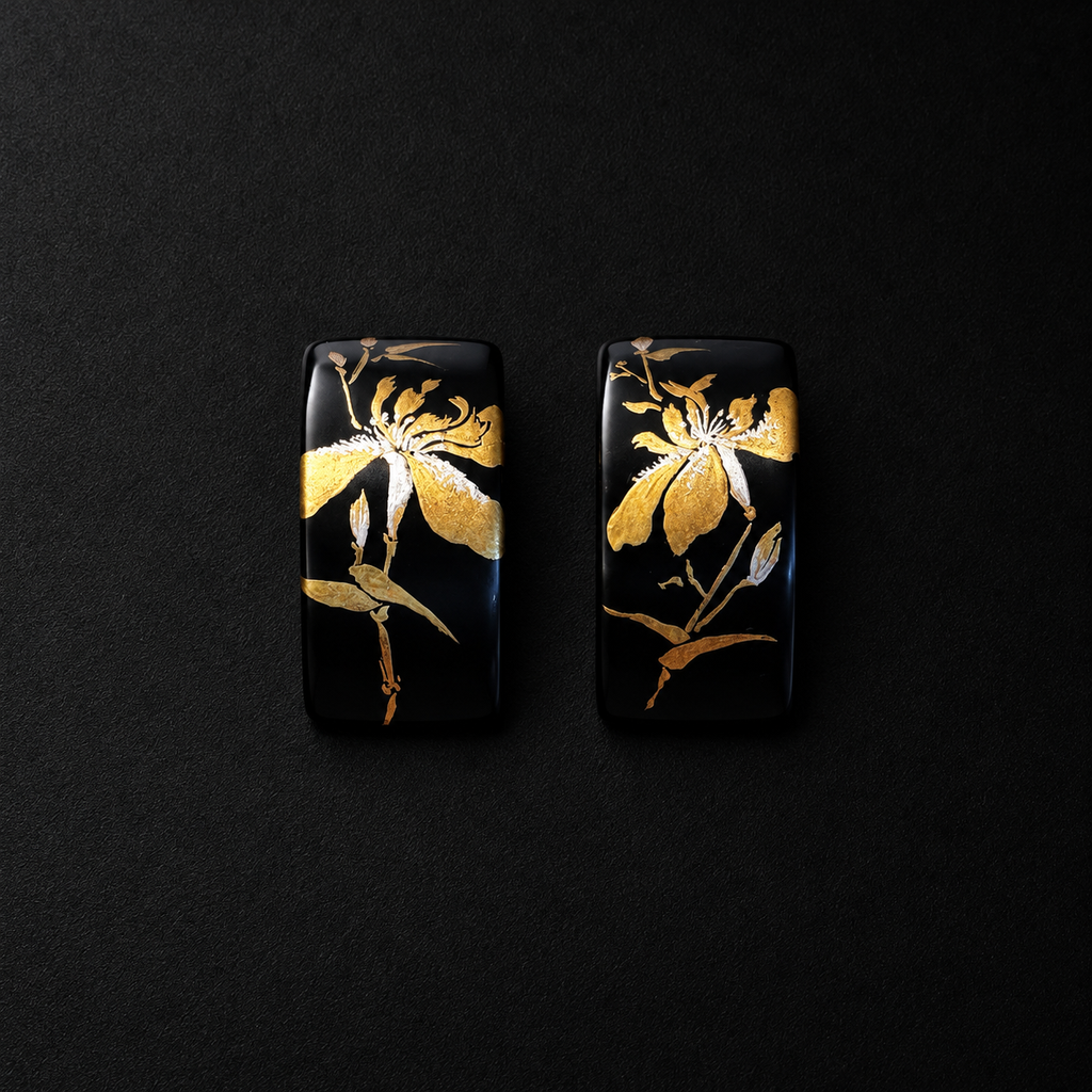 Pair of black rectangular earrings featuring gold-tone iris flower motifs
