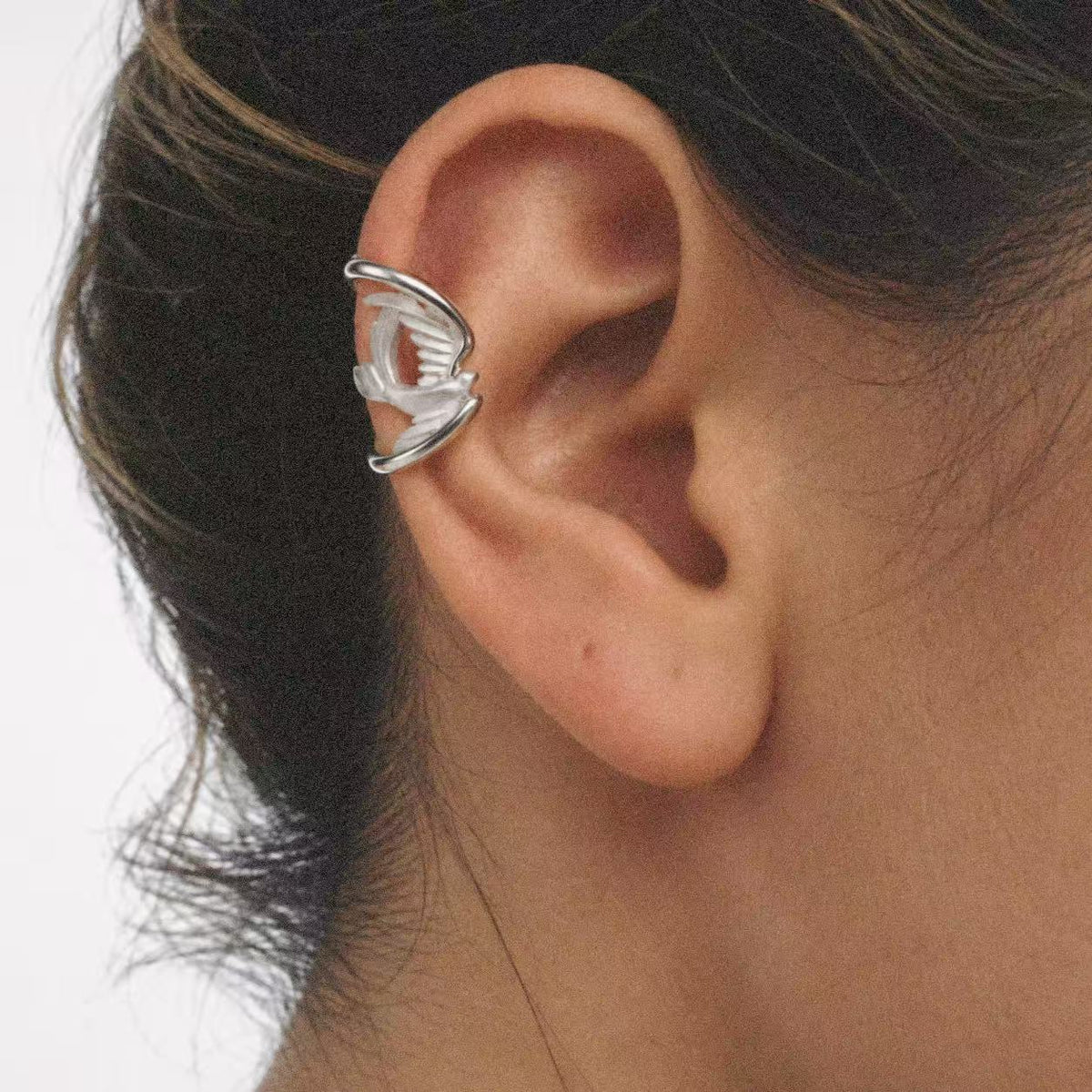 Model wearing the Wing Wrap Ear Cuff seen from the side