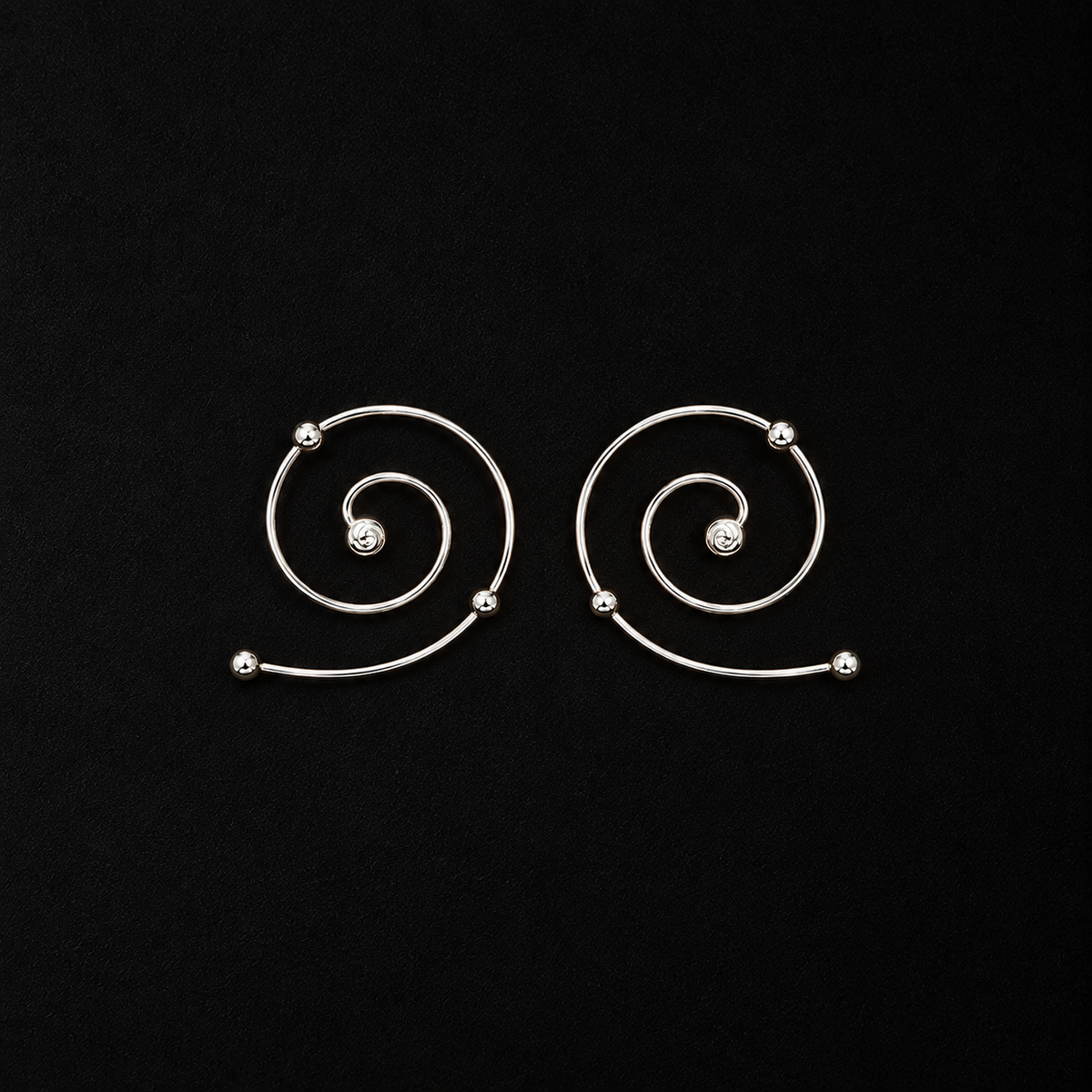 Wire Spiral Ear Climbers shown at a three quarter angle in studio light