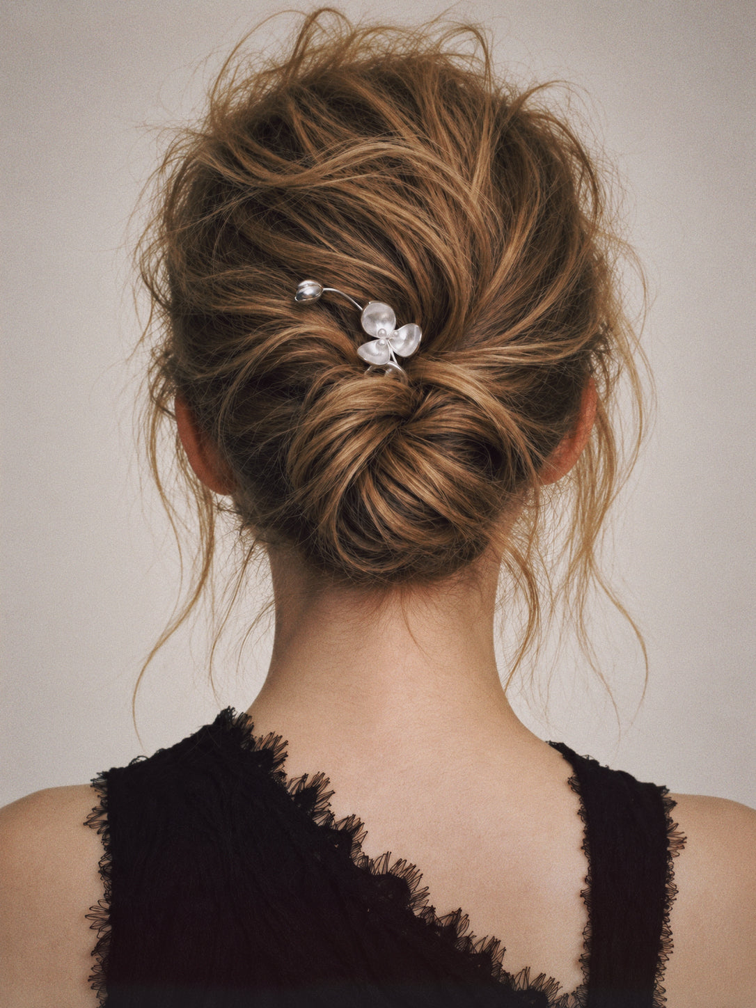 Close-up of the Wisp Orchid French Hair Pin, showing the finish and shape up close