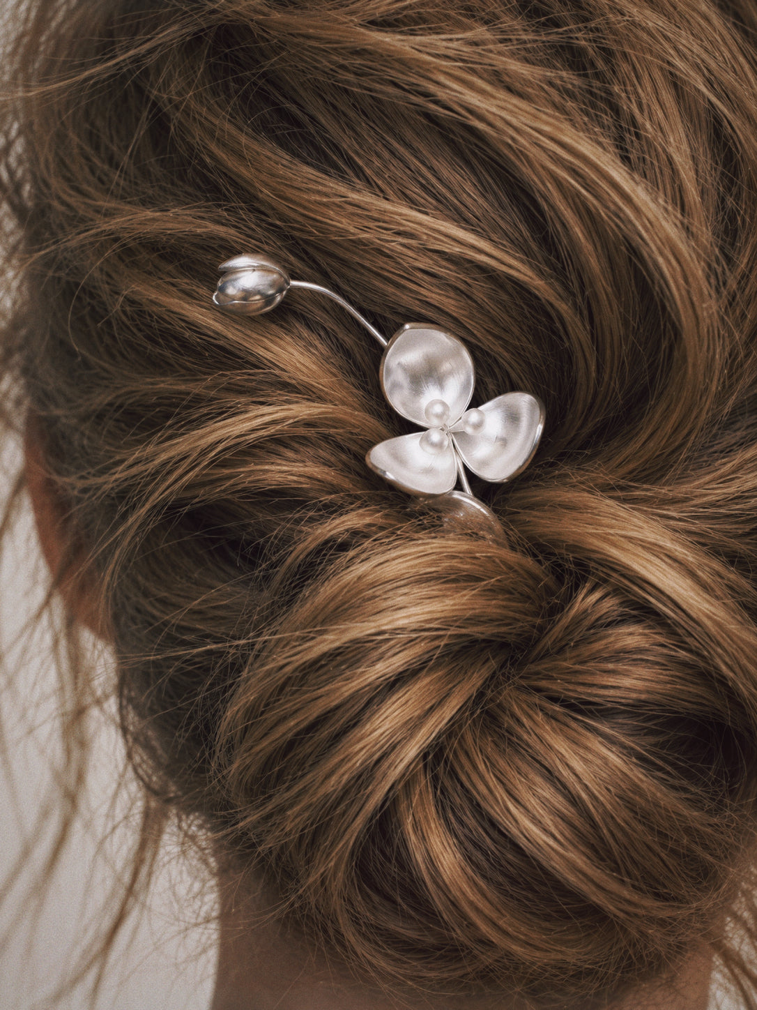 Wisp Orchid French Hair Pin worn in a low bun, french hair pin