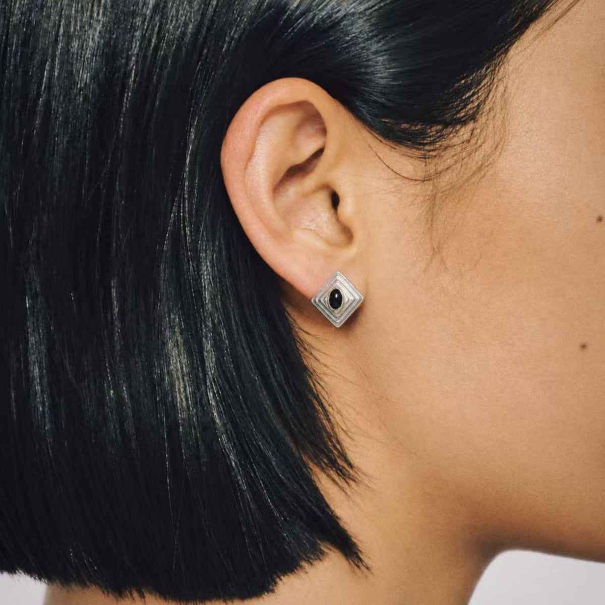 Model wearing the Ziggurat Stepped Stud Earrings, art deco stud earrings