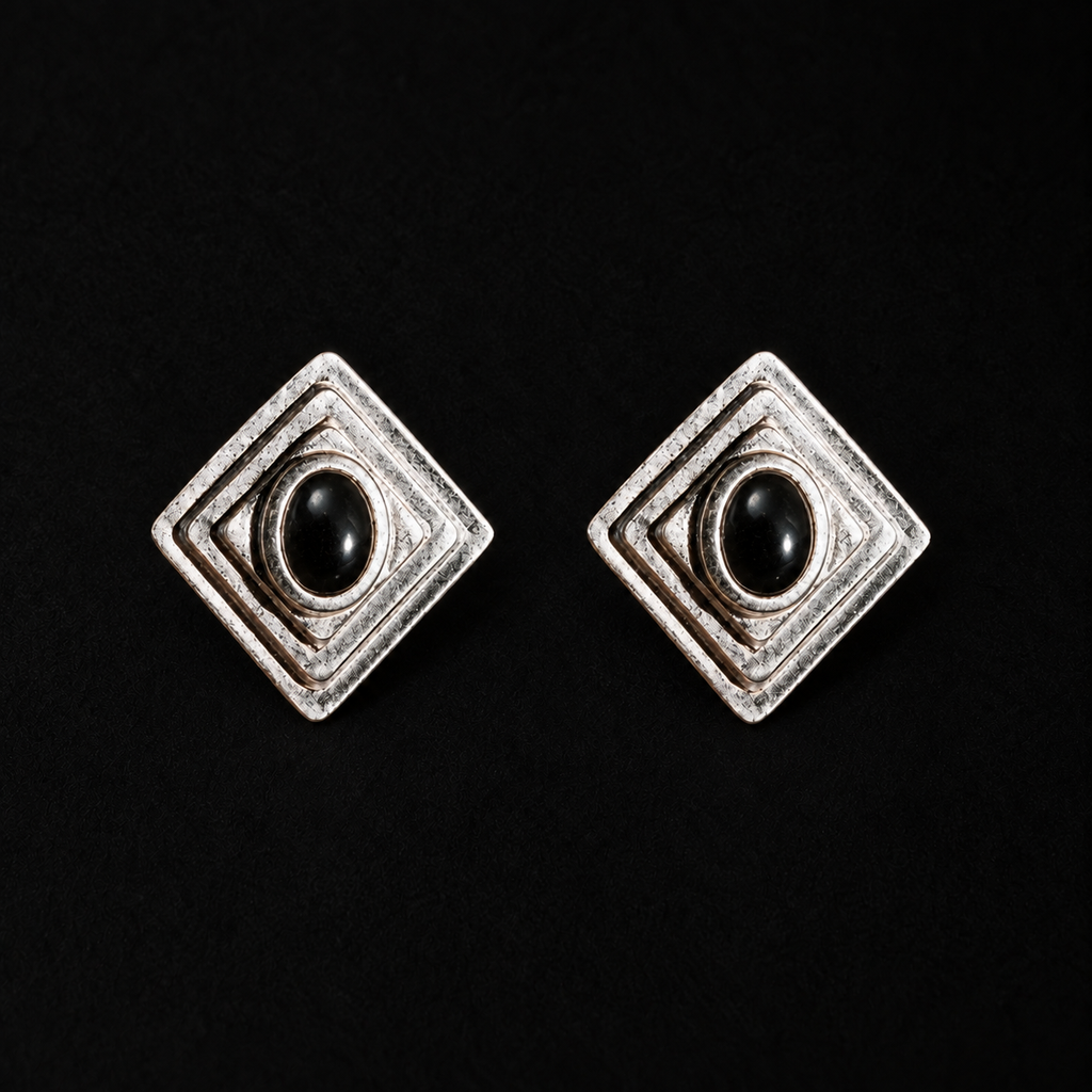 Pair of Ziggurat Stepped Stud Earrings by Lil Cacti, art deco earrings with a black stone in a stepped dark-silver diamond frame, front view