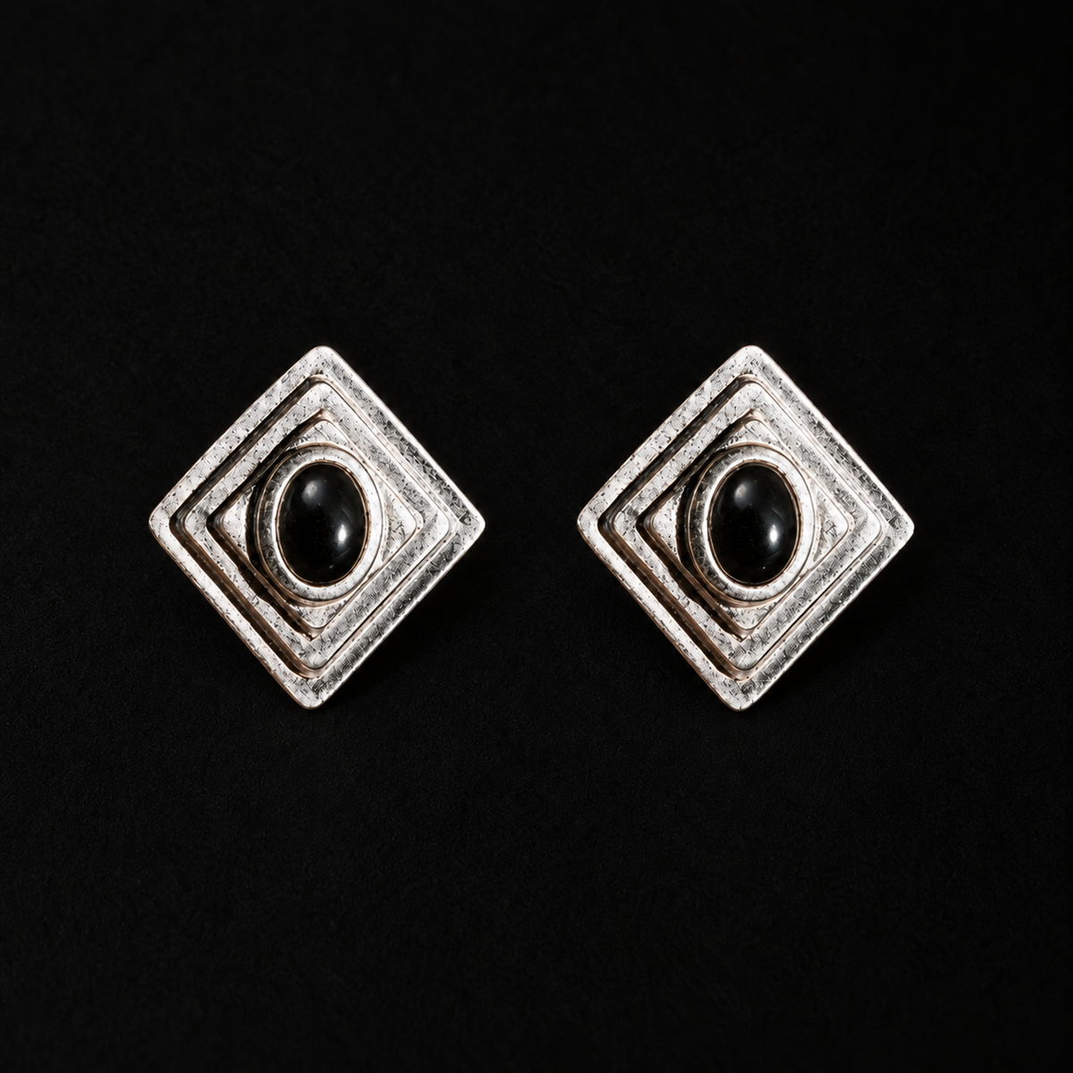 Pair of Ziggurat Stepped Stud Earrings by Lil Cacti, art deco earrings with a black stone in a stepped dark-silver diamond frame, front view