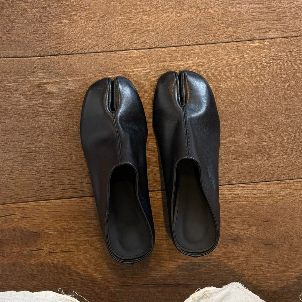 Solene Tabi Wedge Slides by Lil Cacti, top-down view on a wood floor