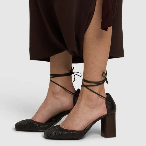 Pair of Lil Cacti brown ankle wrap block heels photographed from above